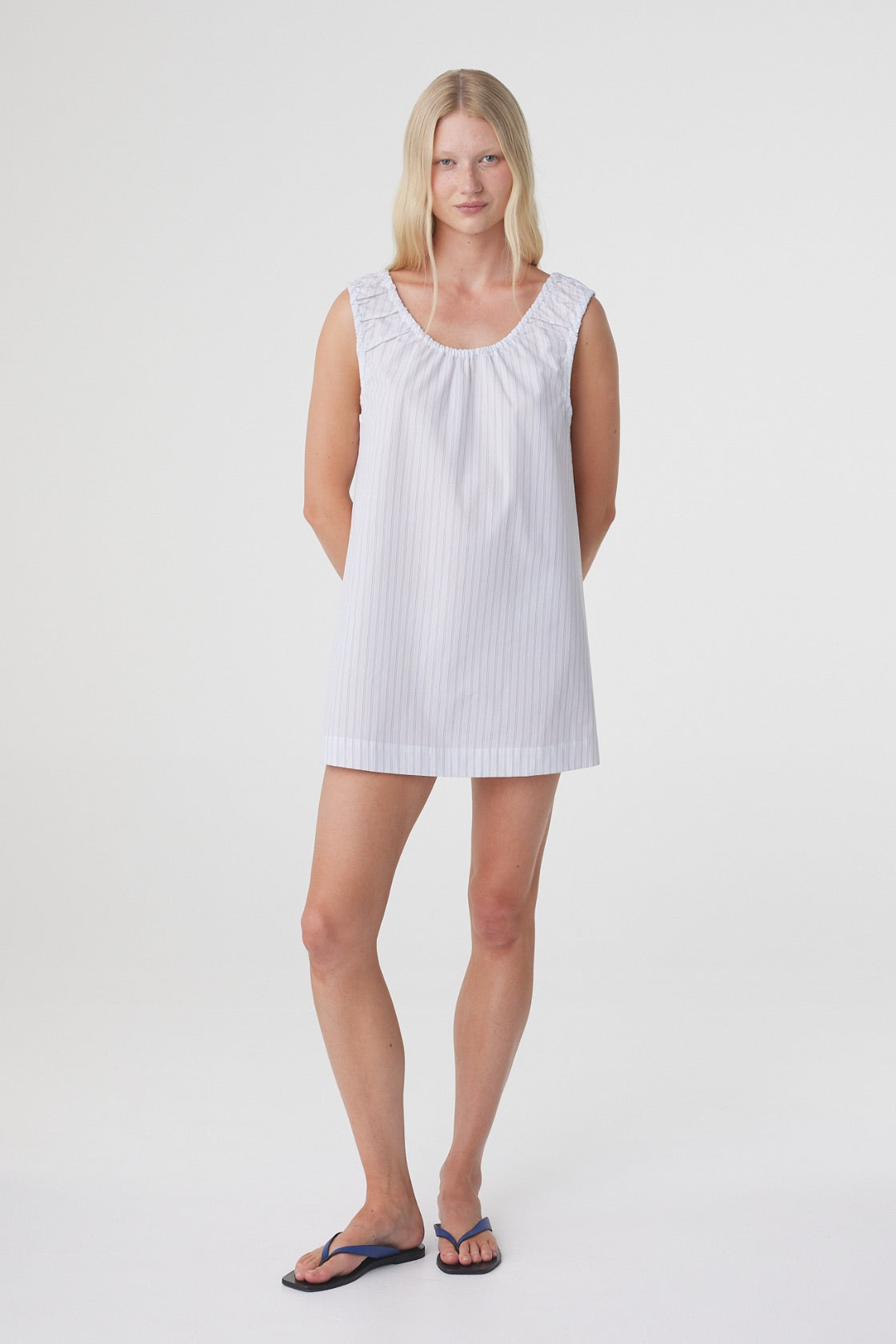 Isla Mini Dress in Blue Pinstripe, relaxed front pose showing the softly gathered neckline and loose silhouette through the body.