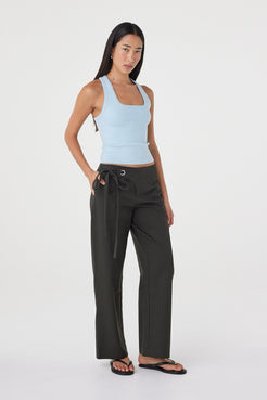 Three-quarter front view of the Lucia Tie Pant in Charcoal showing the straight-leg silhouette, side pockets and adjustable tie closure.