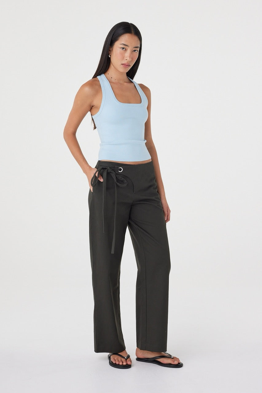 Three-quarter front view of the Lucia Tie Pant in Charcoal showing the straight-leg silhouette, side pockets and adjustable tie closure.