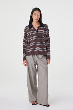 Angled front view of the Rayne Knit in espresso, black and cream styled with relaxed taupe pants, featuring a slouchy fit, long sleeves and soft collared neckline detailing