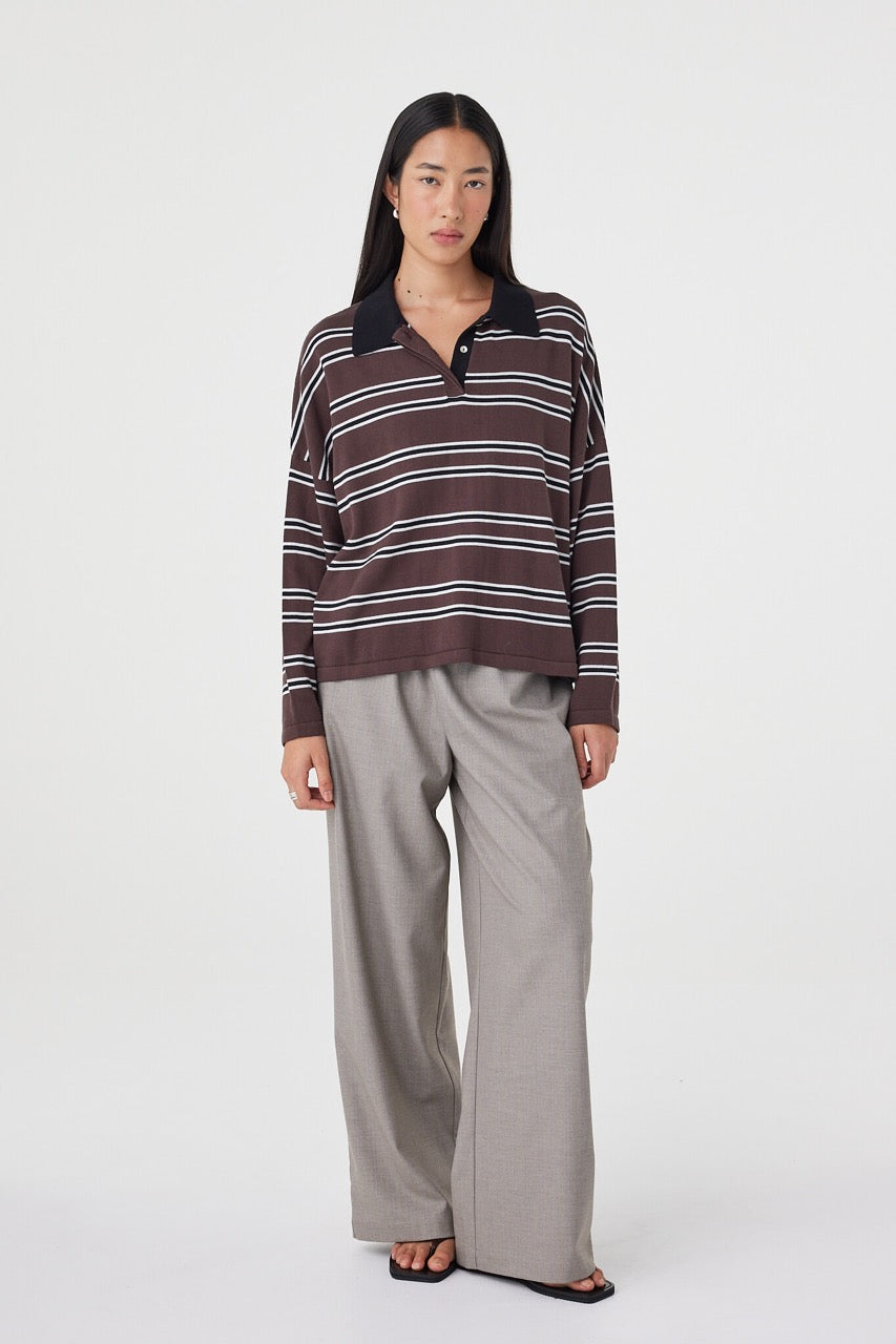 Angled front view of the Rayne Knit in espresso, black and cream styled with relaxed taupe pants, featuring a slouchy fit, long sleeves and soft collared neckline detailing