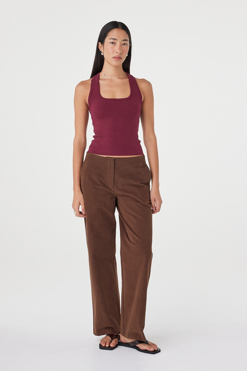 Front view of the Avery Pant in espresso styled with a fitted merlot tank, featuring a straight-leg silhouette, clean waistband and soft drape through the leg