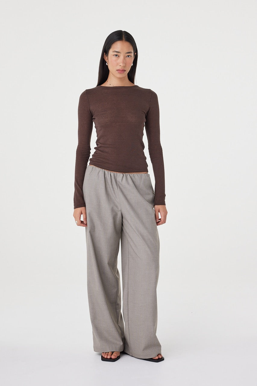 Full-length front view of the Annika Pant in taupe blue pinstripe styled with a slim chocolate brown knit and black sandals, featuring side seam pockets and a soft elasticated waistband