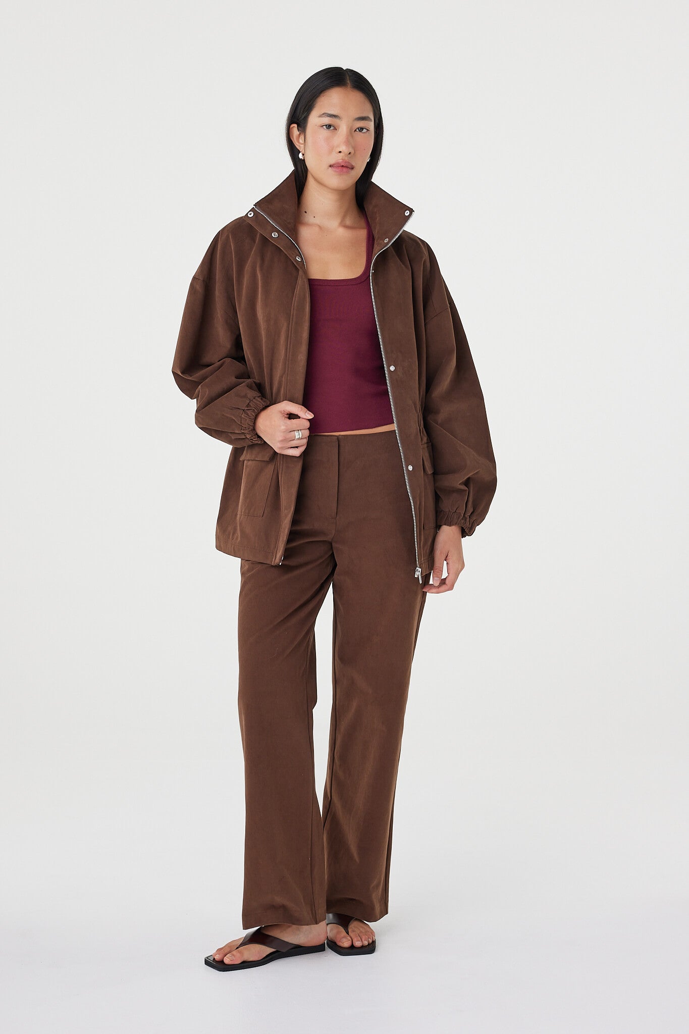 Amari Jacket in espresso worn open over a merlot tank with matching tailored pants and black sandals, highlighting the relaxed layering fit and soft texture