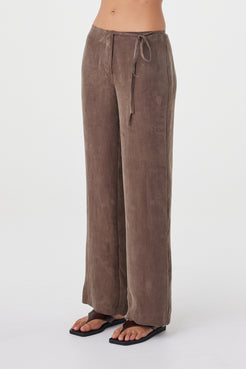 Angled view of the Maisie Tie Pant in Espresso highlighting the mid-rise waist, subtle side tie detail and fluid cupro blend fabrication.