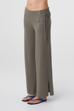Nora Pant in Smokey Olive, angled detail view highlighting the asymmetrical fold over waist, tie detail and split hem.
