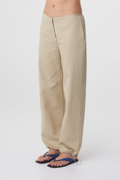 Sabi Pant in Taupe, angled close view showing the relaxed leg and adjustable drawstring hem.