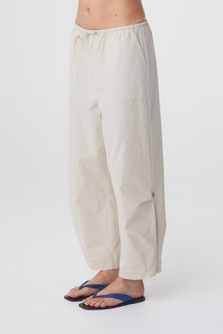 Lena Barrel Pant in Taupe, close side view highlighting the patch pocket and curved shape through the leg.