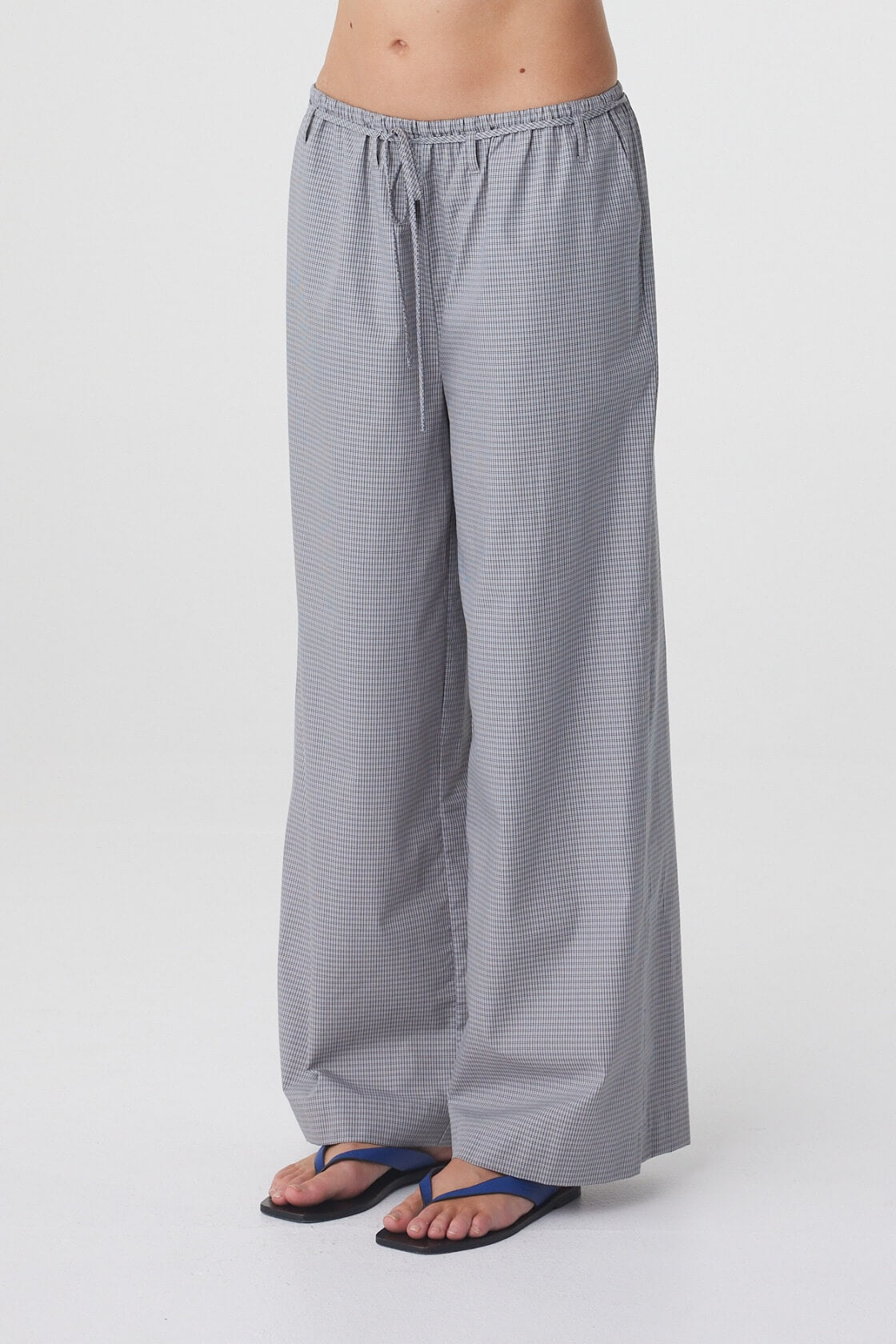 Sia Pant in Muted Blue Check, angled close view showing the relaxed leg and full length hem.
