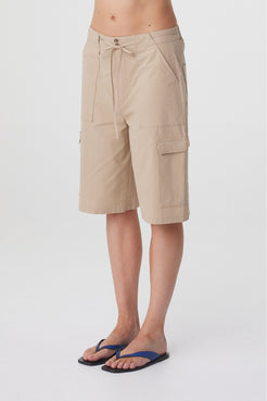 Daria Short in Camel, close three quarter view highlighting the cargo pocket detailing and knee length shape.