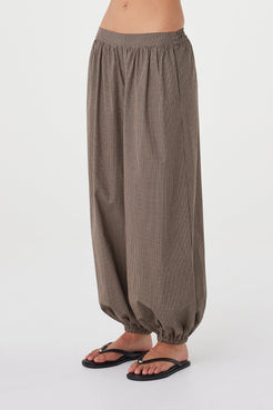 Angled close-up of the Elina Balloon Pant in Chocolate Check showcasing the balloon-leg shape, gathered ankle detail and soft cotton fabrication.