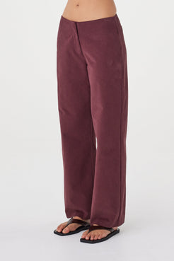 Side view of the Avery Pant in Merlot highlighting the relaxed leg shape and fluid drape.