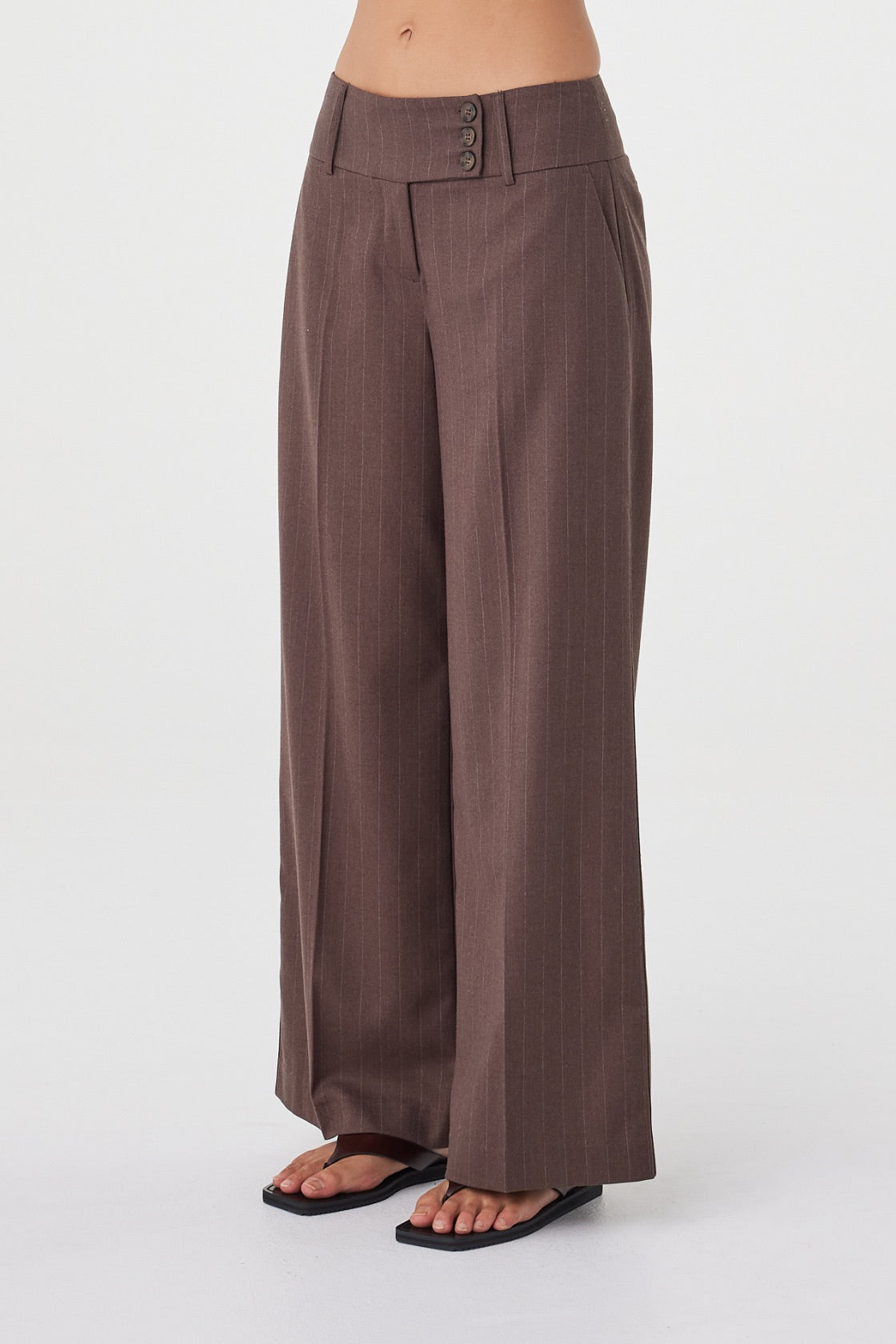 Side detail view of the Manon Pant in Espresso Pinstripe showcasing the tailored waistband, soft structured fabrication and wide-leg profile.