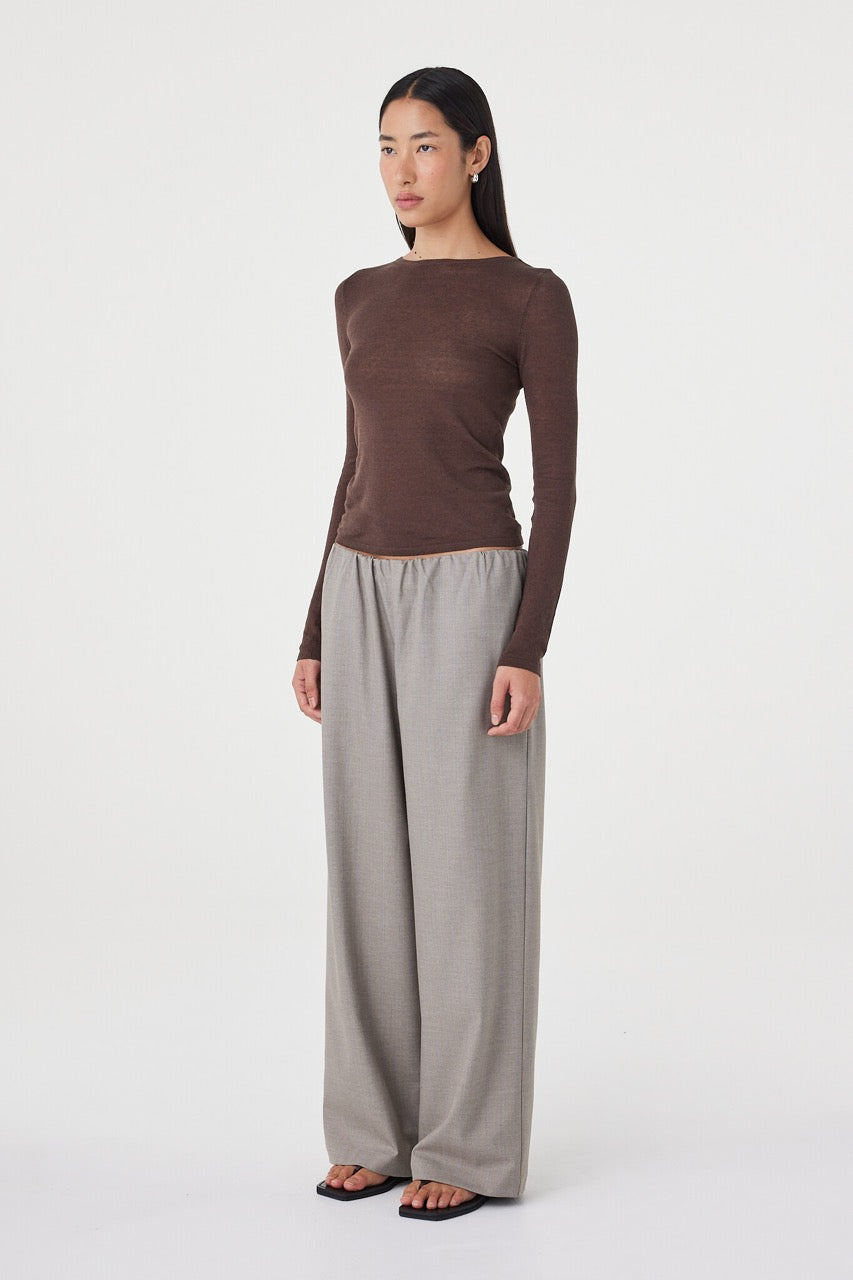 Full-length angled view of the Annika Pant in taupe blue pinstripe styled with a fitted chocolate brown knit top and black sandals for an elevated everyday loo