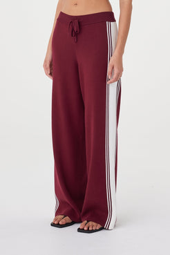 Close-up view of the Emery Pant in merlot highlighting the cream contrast stripe, ribbed waistband with drawcord and contrasting waist tie detail
