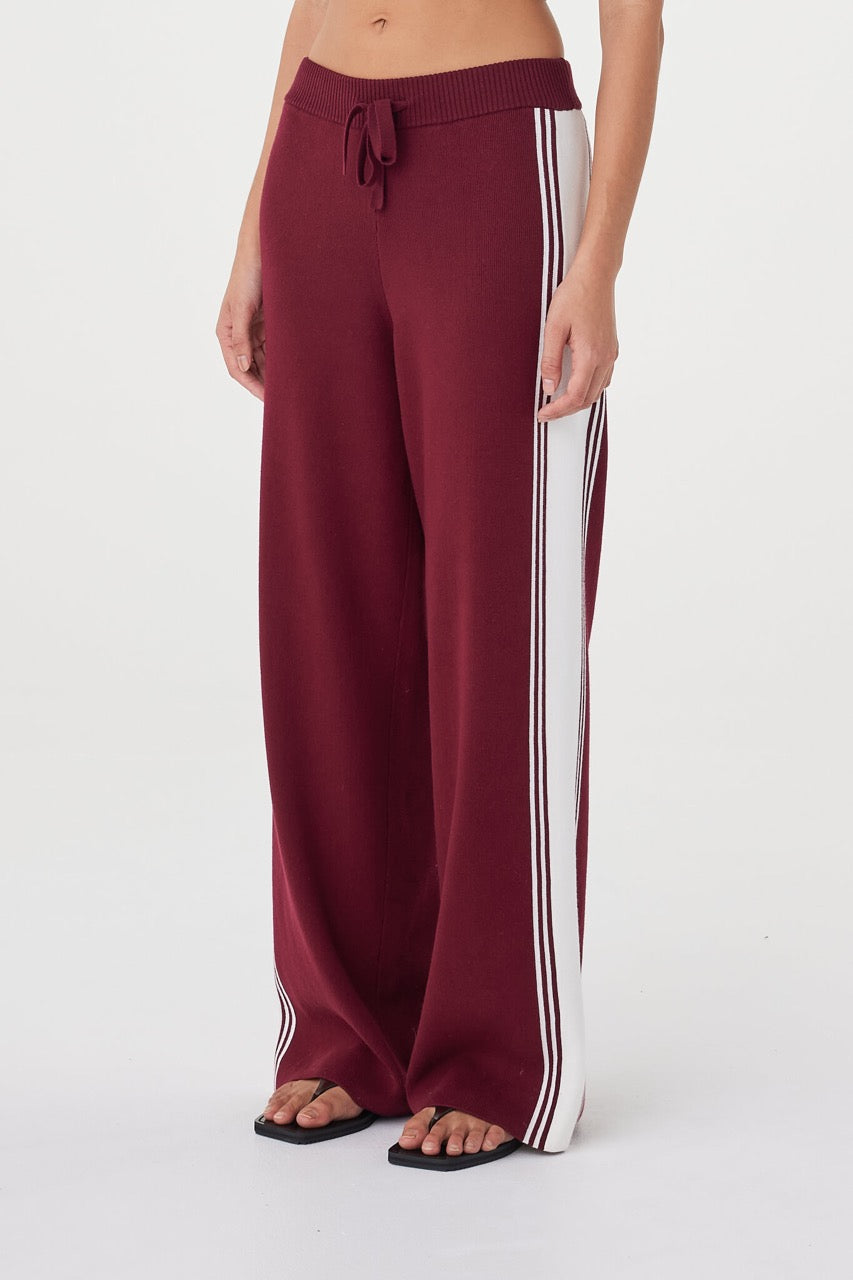 Close-up view of the Emery Pant in merlot highlighting the cream contrast stripe, ribbed waistband with drawcord and contrasting waist tie detail