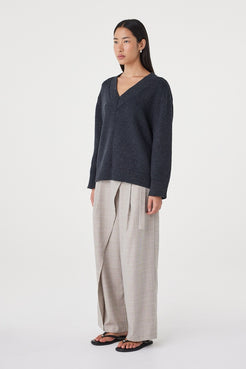 Side view of the Zenya Sweater in Dark Grey Marle highlighting the dropped shoulder construction and soft, off-body shape.
