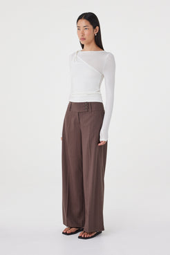 Side view of the Manon Pant in Espresso Pinstripe highlighting the relaxed wide-leg silhouette and fluid drape through the leg.