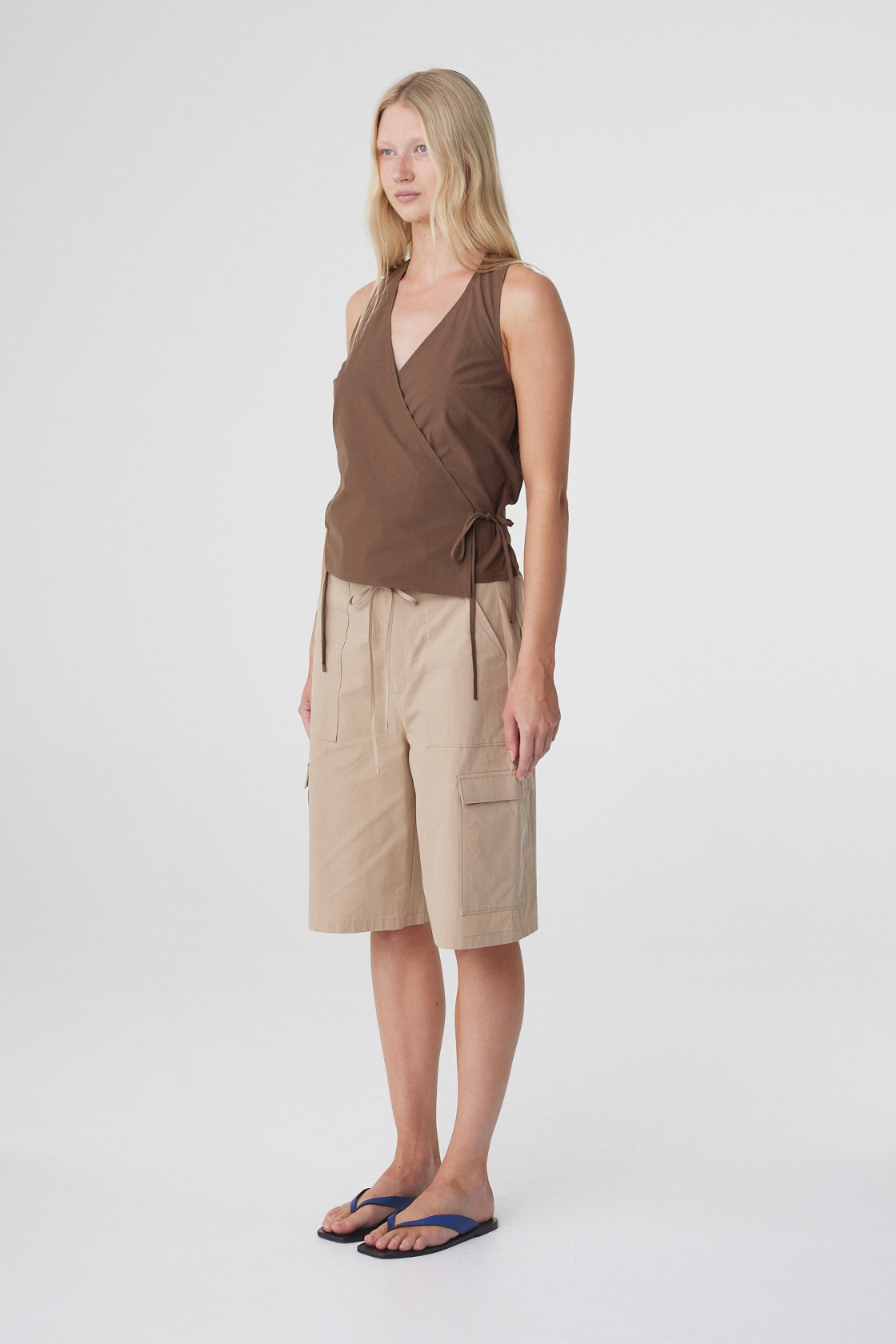 Daria Short in Camel, three quarter view styled with a brown wrap top, showing the relaxed long length.