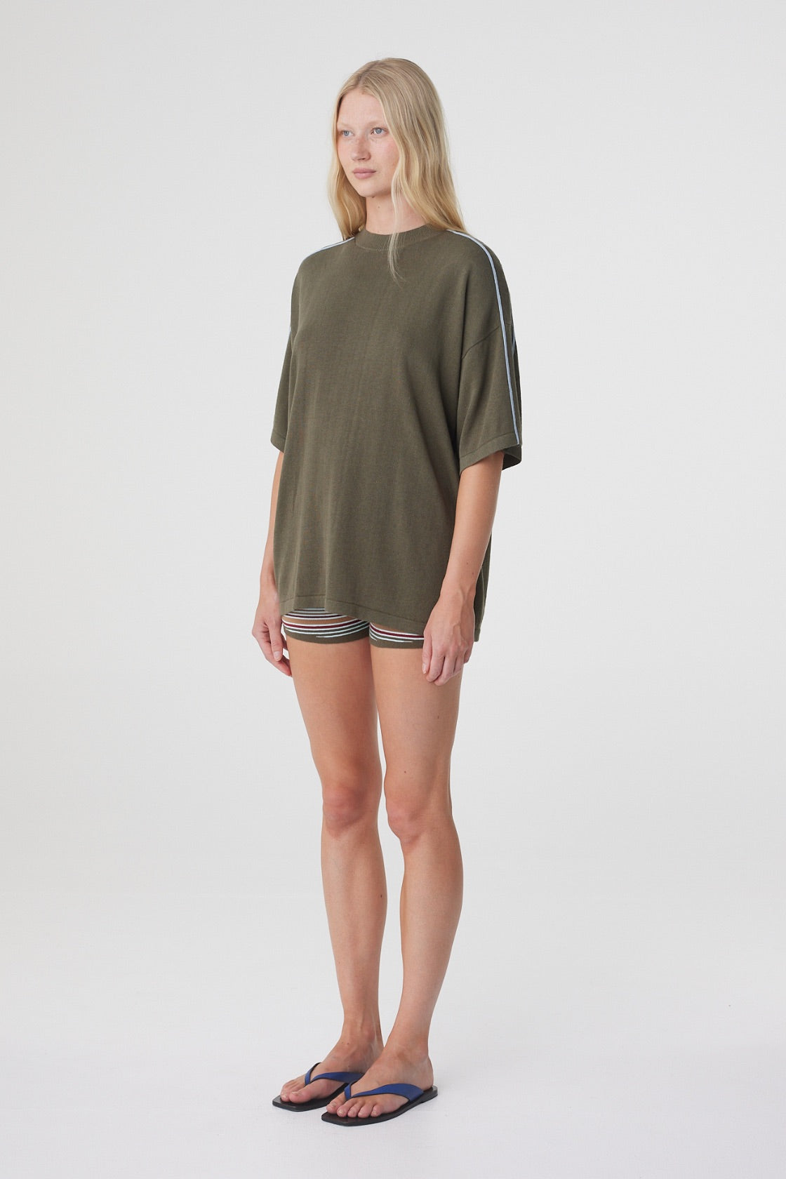 Pippa Oversized Tee in Smokey Olive and Dusk Blue, three quarter view highlighting the dropped shoulder and contrast piping detail.