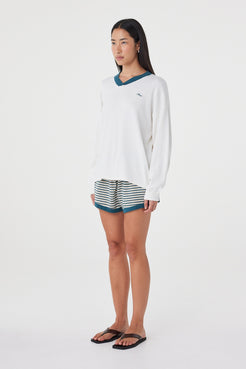 Side view of the Cammy LS Tee in Cream & Teal showing the extra oversized silhouette, relaxed long sleeves and contrast ribbed neckline.