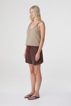 Pippa Midi Short in Espresso & Chilli, three quarter view showing the mid rise fit, longer length and contrast side piping.