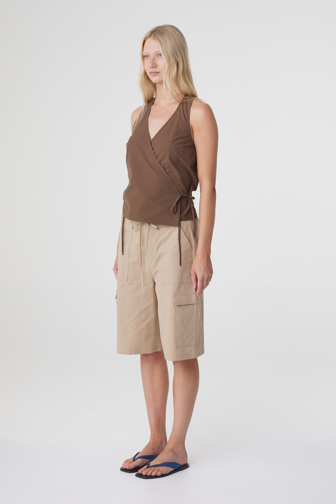 Lilia Wrap Top in Espresso, three quarter view showing the deep V neckline and relaxed shape through the body.