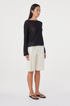 Angled full-length view of the Lucia Tie Bermuda Short in Bone showing the relaxed fit through the hip and straight knee-length silhouette.