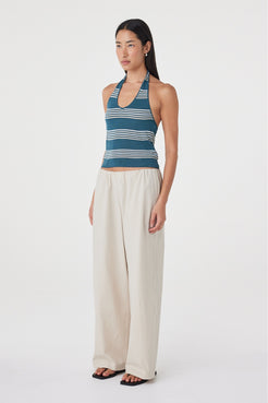 Side view of the Nuri Top in Teal Stripe highlighting the open shoulder, fitted profile and halterneck construction.