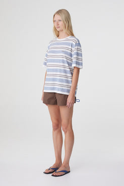 Addie Short in Espresso, three quarter view styled with an oversized blue and cream striped tee, showing the relaxed fit and mini length.