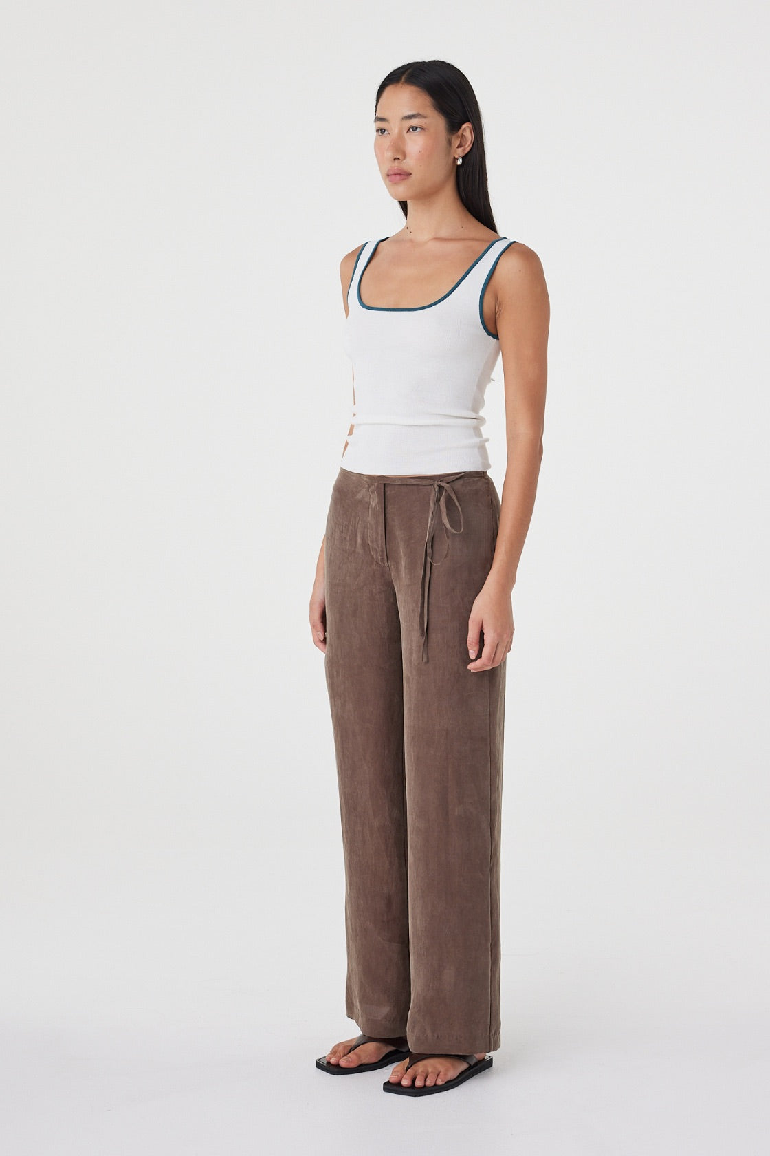 Side view of the Kaya Tank in Cream & Teal showing the slim silhouette, fitted body and contrast edging.