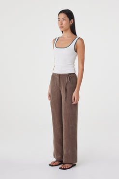 Side view of the Kaya Tank in Cream & Teal showing the slim silhouette, fitted body and contrast edging.