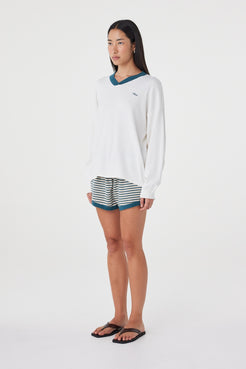 Angled full-length view of the Netta Shorts in Teal Cream Stripe paired with the Cammy LS Tee, showing the side stripe detailing and easy fit.
