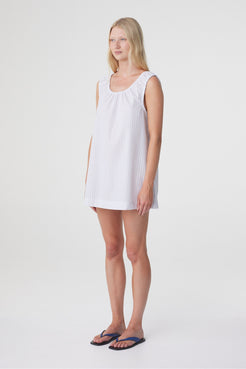 Isla Mini Dress in Blue Pinstripe, three quarter front view highlighting the loose shape, sleeveless cut and mini length.