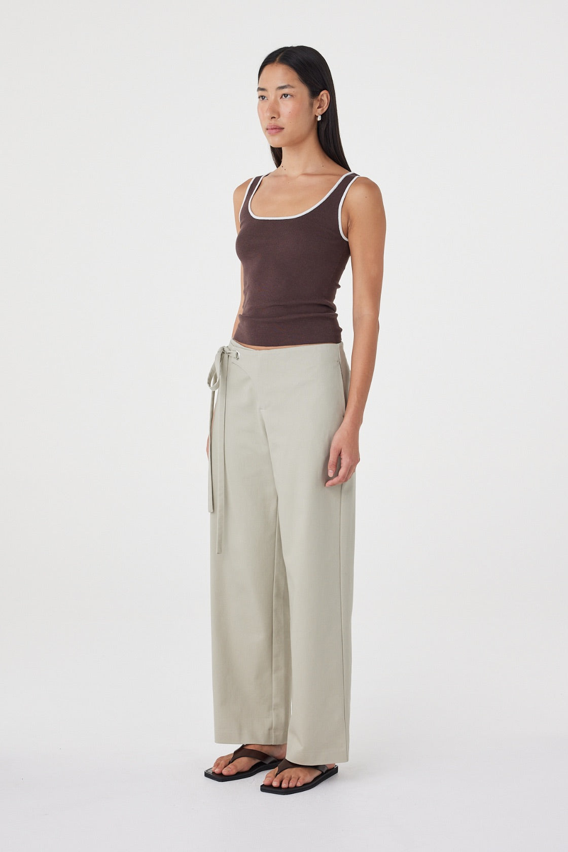 Side view of the Lucia Tie Pant in Light Sage highlighting the relaxed straight-leg silhouette, functional side seam pockets and effortless drape.