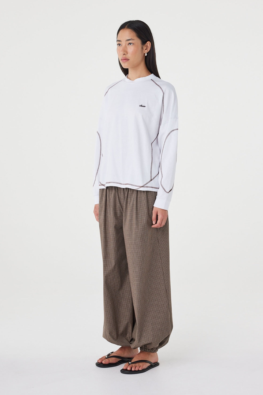 Side view of the Kesh LS Tee in Cream & Espresso featuring the relaxed off-body silhouette, ribbed cuffs and contrast seam detailing.
