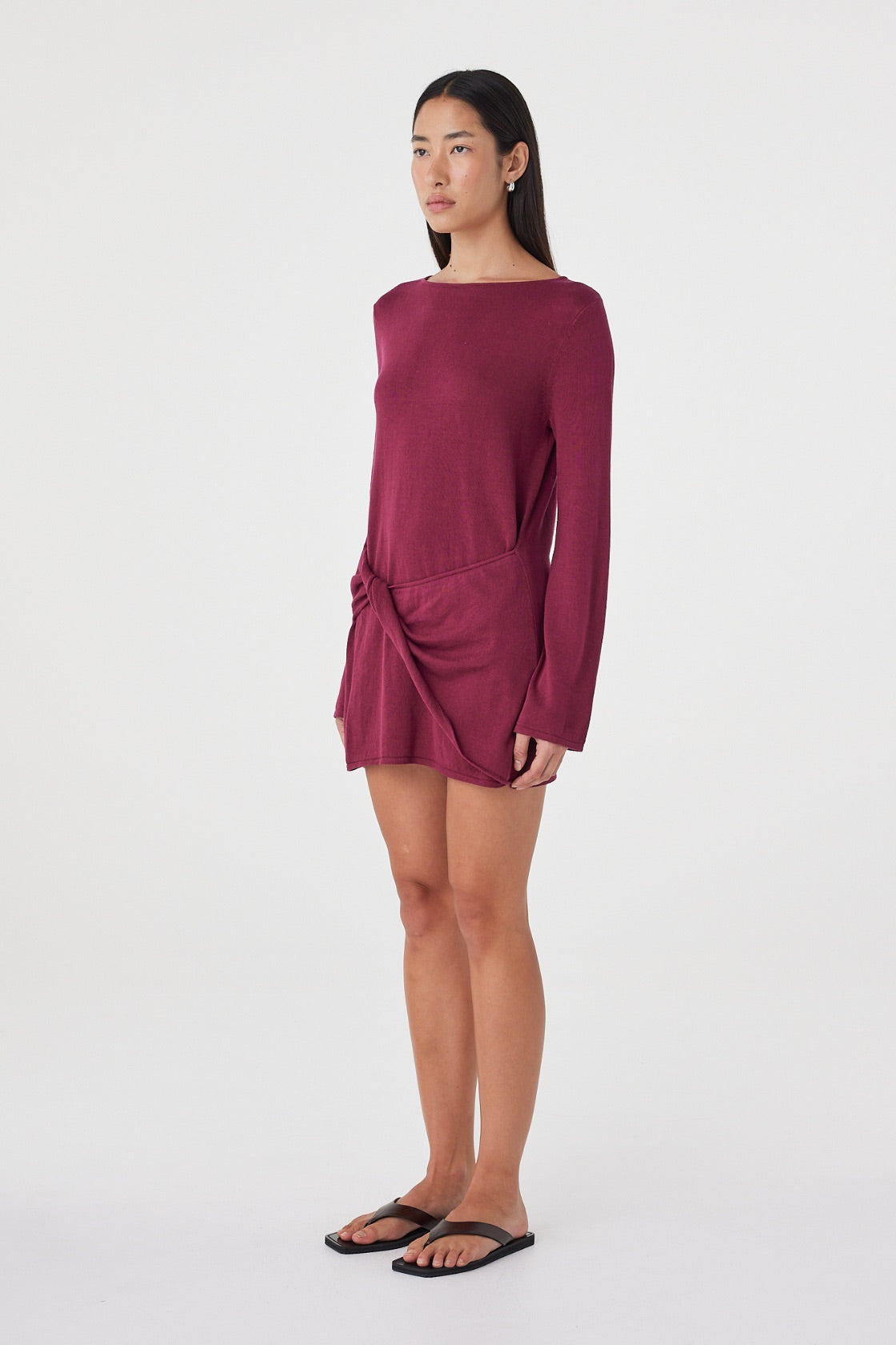 Side view of the Kira Mini Dress in Merlot highlighting the mini length, boat neckline and effortless drape through the body.