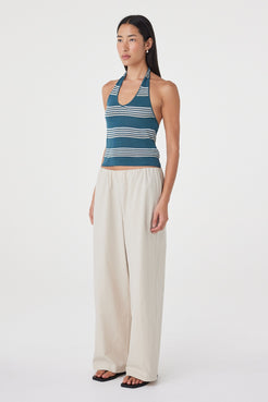 Side view of the Annika Pant in Taupe paired with a striped tank, showing the relaxed fit through the waist and hip.