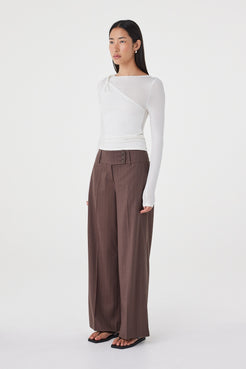 Side view of the Mabel LS Twist Top in Cream featuring the front shoulder twist detail, slim fit and clean profile.