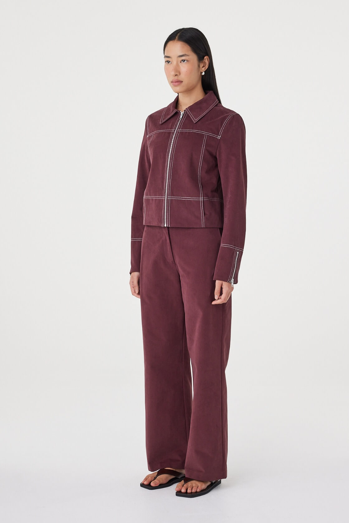 Angled side view of the Avery Pant in Merlot showcasing the tailored fit and full-length leg.
