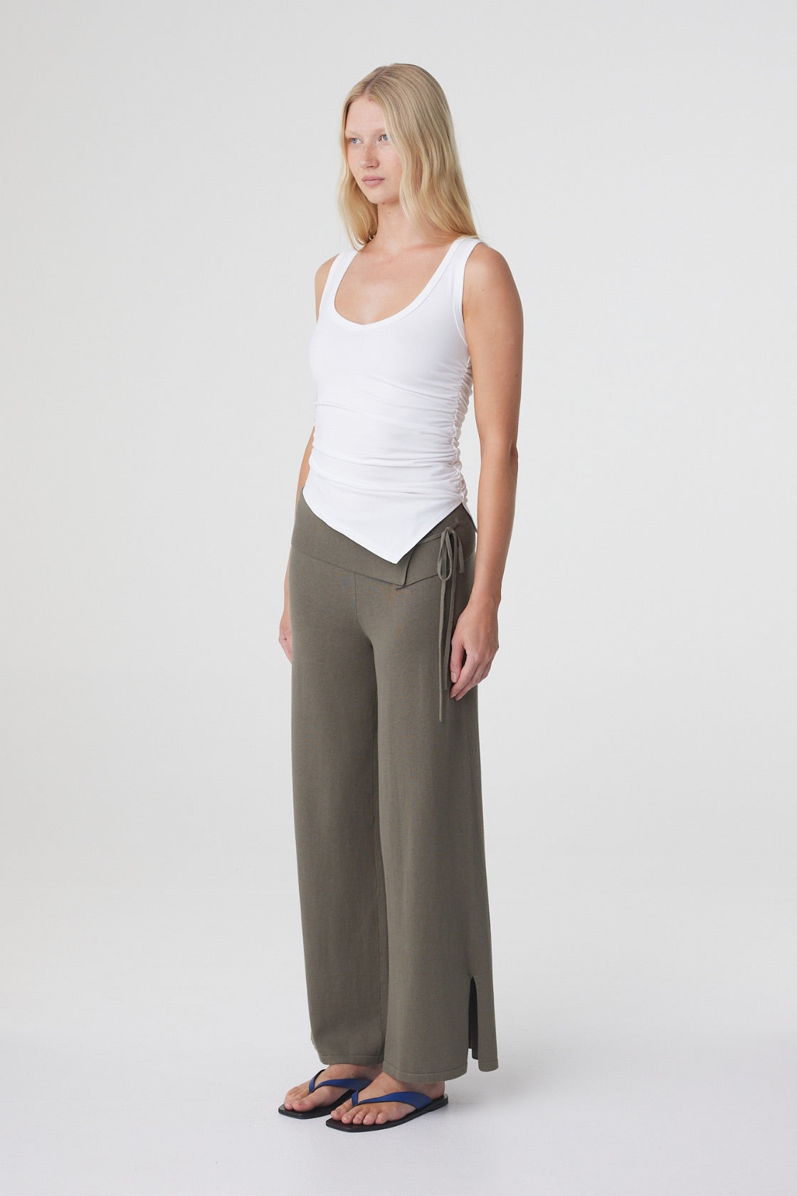Nora Pant in Smokey Olive, full length side view showing the relaxed drape and side seam split at the hem.