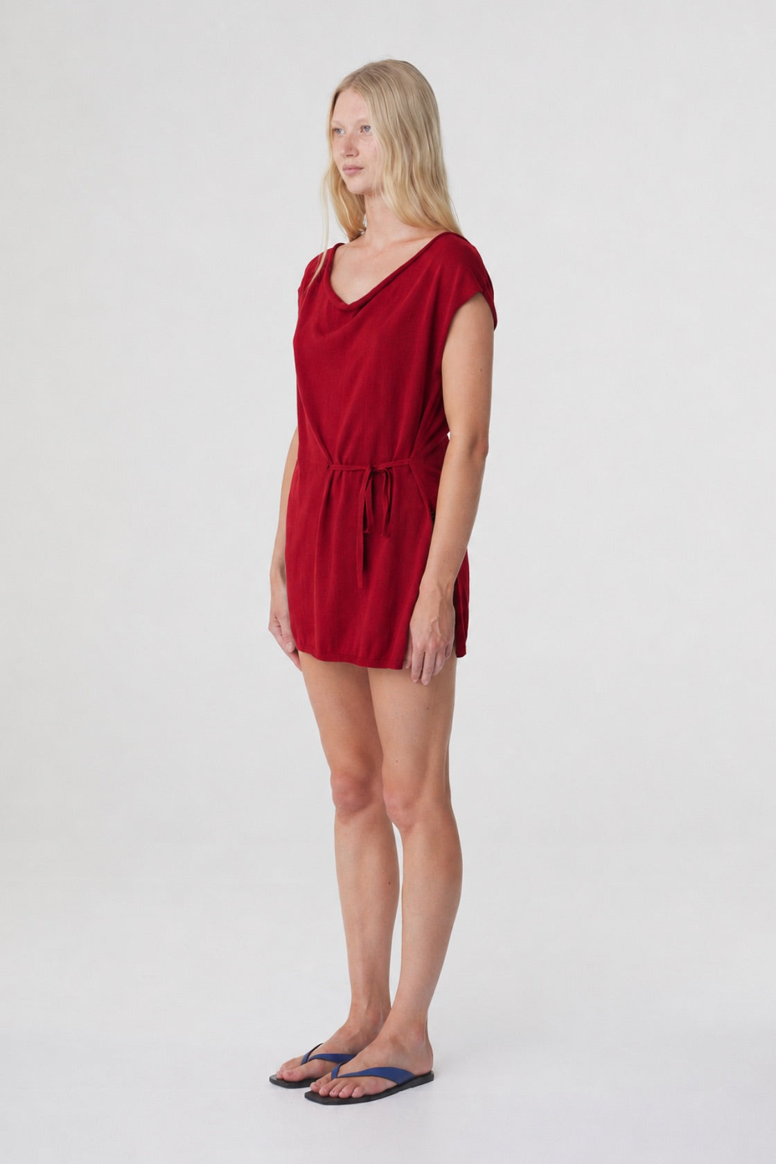 Nora Top in Chilli, three quarter view showing the softly draped neckline, side seam split and longline shape.