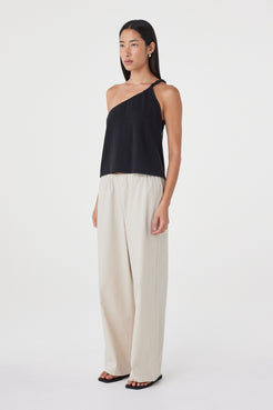 Side view of the Harri Asym Top in Black showing the one-shoulder construction and easy, off-body drape.