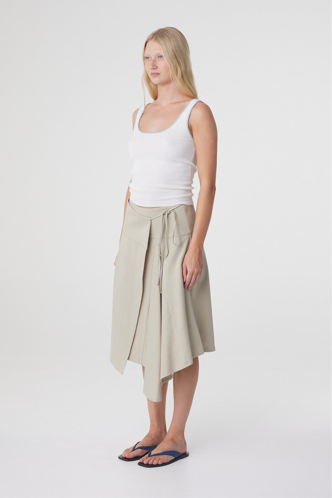 Anya Skirt in Taupe, three quarter view showing the relaxed midi silhouette and movement through the godet panels.
