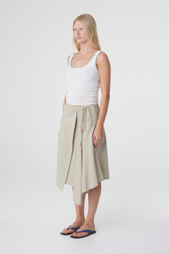 Anya Skirt in Taupe, three quarter view showing the relaxed midi silhouette and movement through the godet panels.
