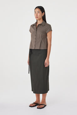 Side view of the Freya Shirt in Chocolate Check featuring the slim silhouette, cap sleeves and lightweight cotton fabrication.
