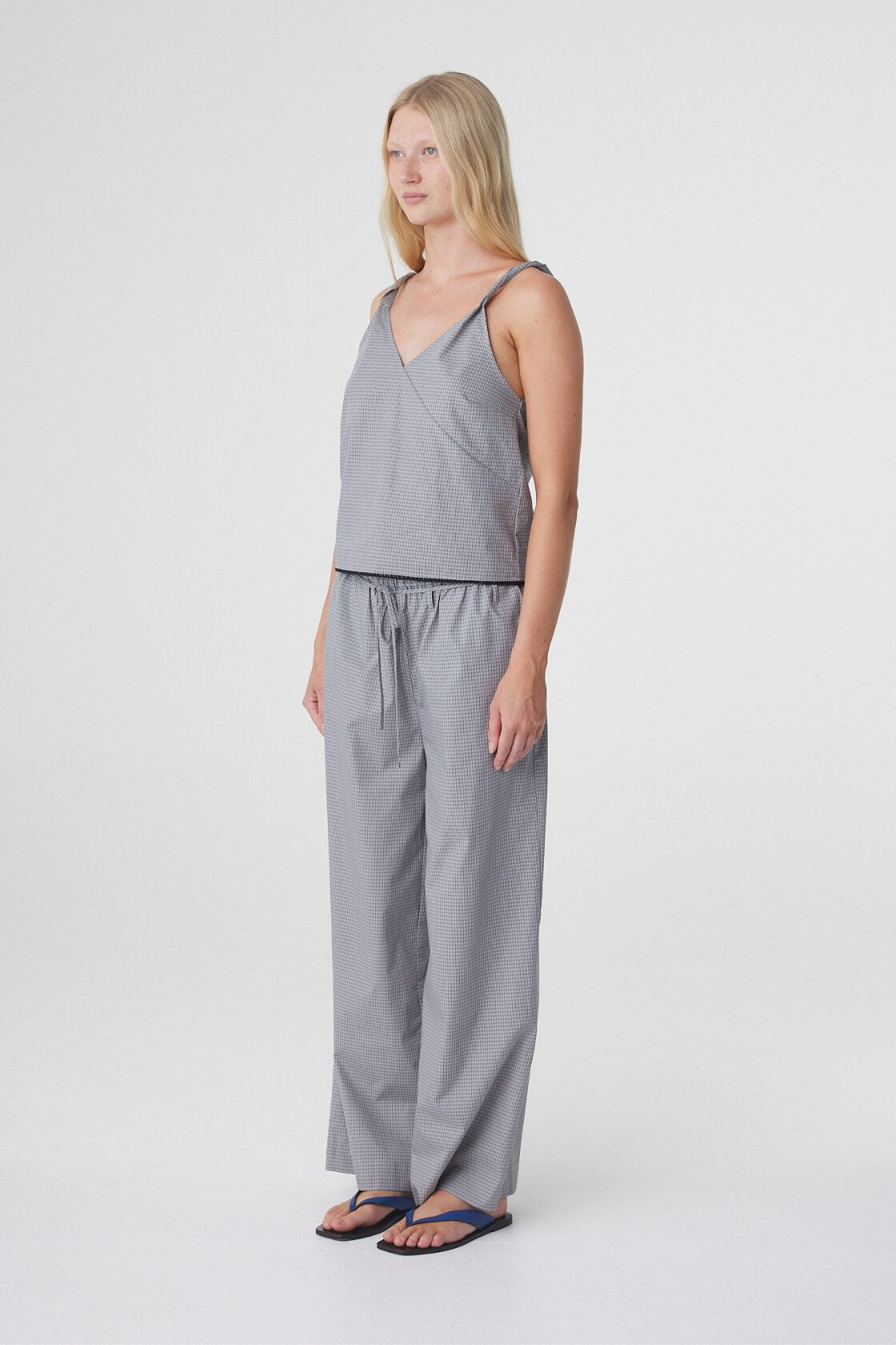 Sia Pant in Muted Blue Check styled with the matching top, three quarter view showing the relaxed fit through the leg.