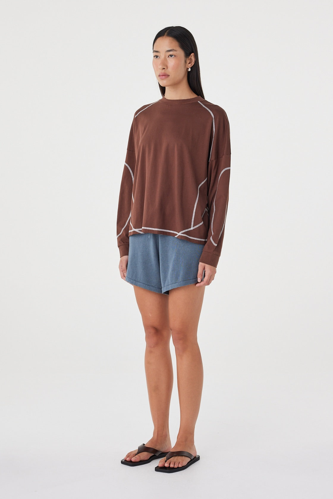 Side view of the Kesh LS Tee in Espresso & Cream featuring the relaxed off-body silhouette, ribbed cuffs and contrast seam detailing.