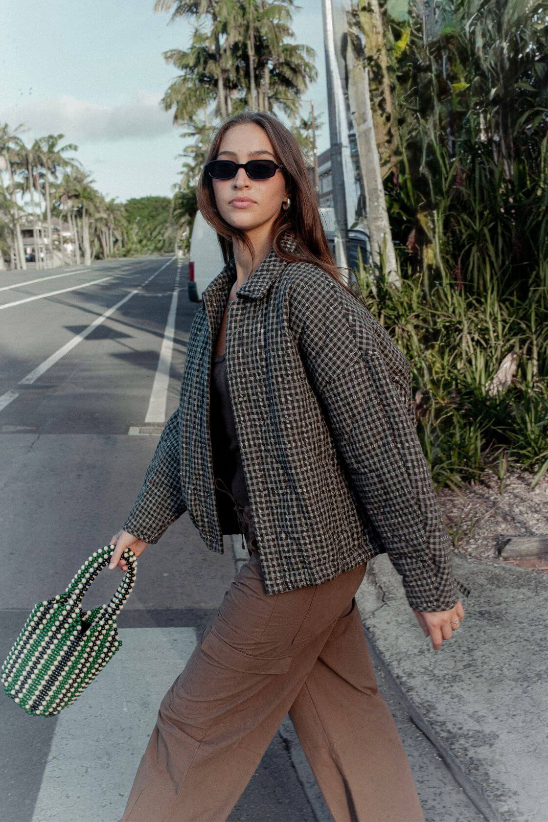 Model wearing Espresso Check quilted cotton jacket with slouchy cocoon fit, styled over espresso cargo pants for cool evenings