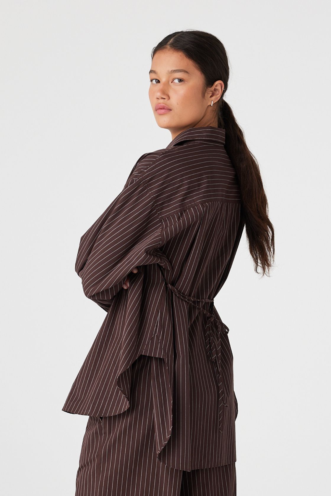 Back view of oversized cotton shirt with espresso stripe, waist tie loosely fastened